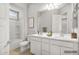 Bright bathroom featuring dual sinks, a framed mirror, tub-shower, and a neutral color palette at 32297 N 133Rd Ln, Peoria, AZ 85383