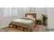 Cozy bedroom featuring a wood-accented bed frame, storage drawers, and plush bedding at 32297 N 133Rd Ln, Peoria, AZ 85383