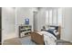 Stylized bedroom with a wood frame bed, shelving, and abundant light from a window with shutter at 32297 N 133Rd Ln, Peoria, AZ 85383