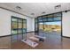 Bright fitness room with modern windows showcasing mountain views and access to an outdoor patio at 32297 N 133Rd Ln, Peoria, AZ 85383