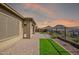 Wide brick paved patio with mountain views at sunset at 32297 N 133Rd Ln, Peoria, AZ 85383