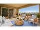 Inviting covered patio featuring comfortable seating and views at 32297 N 133Rd Ln, Peoria, AZ 85383