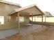 View of covered back patio with a table and stone landscaping at 39837 N Manetti St, San Tan Valley, AZ 85140
