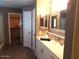 Bright bathroom featuring a vanity with double sinks and decorative mirrors at 39837 N Manetti St, San Tan Valley, AZ 85140