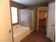Bathroom with a large tub and shower combination and a separate closet at 39837 N Manetti St, San Tan Valley, AZ 85140