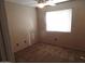 Inviting bedroom featuring neutral carpeting, a bright window with natural light, and a fan at 39837 N Manetti St, San Tan Valley, AZ 85140