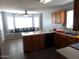 Modern eat-in kitchen featuring stainless steel appliances, an island with bar seating, and a window seat area at 39837 N Manetti St, San Tan Valley, AZ 85140
