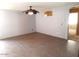 Empty living room with tile floor, ceiling fan, and neutral paint at 39837 N Manetti St, San Tan Valley, AZ 85140