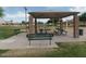 Community pavilion featuring picnic benches and seating in a green space with a playground, perfect for outdoor gatherings at 39837 N Manetti St, San Tan Valley, AZ 85140