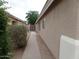 Side view showcasing the home's exterior, walkway, and desert landscaping at 39837 N Manetti St, San Tan Valley, AZ 85140