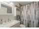 Neutral colored bathroom with marble vanity, shower and curtain, and toilet at 40192 N Taylor St, San Tan Valley, AZ 85140