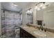 Bathroom with dual sinks, tile shower and floors and light fixture at 40192 N Taylor St, San Tan Valley, AZ 85140