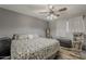 Bedroom with a comfortable bed, ceiling fan, and view to the backyard at 40192 N Taylor St, San Tan Valley, AZ 85140
