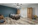 Bedroom with wood-look floors, ceiling fan, and gray and teal walls at 40192 N Taylor St, San Tan Valley, AZ 85140