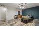 Bedroom with wood-look floors, ceiling fan, and gray and teal walls at 40192 N Taylor St, San Tan Valley, AZ 85140