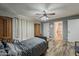 Bedroom with wood-look floors, ceiling fan, and access to bathroom at 40192 N Taylor St, San Tan Valley, AZ 85140