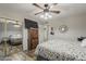 This bedroom includes wood-look floors, ceiling fan, and mirrored closet doors at 40192 N Taylor St, San Tan Valley, AZ 85140