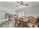 Open dining area with wood-look floors and a full kitchen in the background at 40192 N Taylor St, San Tan Valley, AZ 85140