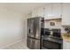 Clean kitchen featuring stainless steel refrigerator and white cabinetry at 40192 N Taylor St, San Tan Valley, AZ 85140