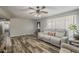 Inviting living room featuring modern flooring, a ceiling fan and a comfortable sofa at 40192 N Taylor St, San Tan Valley, AZ 85140
