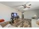 Open-concept living room with modern flooring, a ceiling fan, and comfortable white sofa at 40192 N Taylor St, San Tan Valley, AZ 85140