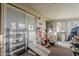 Sun room with lots of clutter, windows, and a sliding door at 40192 N Taylor St, San Tan Valley, AZ 85140