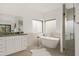 Bright bathroom with a soaking tub, walk-in shower, and a double sink vanity at 40198 N 105Th Pl, Scottsdale, AZ 85262