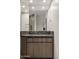 Bathroom vanity with wood cabinets, marble countertop, vessel sink and large mirror at 40198 N 105Th Pl, Scottsdale, AZ 85262