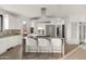 Modern kitchen with stainless steel appliances, a center island, and breakfast bar seating at 40198 N 105Th Pl, Scottsdale, AZ 85262