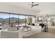 Open concept living room with a view of the backyard pool, kitchen, and desert landscape at 40198 N 105Th Pl, Scottsdale, AZ 85262