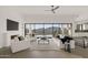 Bright open living room with modern furnishings and floor to ceiling windows overlooking the desert landscape at 40198 N 105Th Pl, Scottsdale, AZ 85262