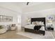 Spacious bedroom with ceiling fan, upholstered headboard, and sitting area at 40198 N 105Th Pl, Scottsdale, AZ 85262