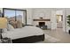 Bedroom with sliding glass doors leading to a balcony with mountain views and a fireplace at 40198 N 105Th Pl, Scottsdale, AZ 85262