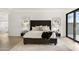 Bright bedroom with upholstered headboard, nightstands with lamps, and a seating area at 40198 N 105Th Pl, Scottsdale, AZ 85262