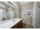 Well-lit bathroom featuring a mirrored vanity, tiled floors, and a walk-in shower at 40360 W Hayden Dr, Maricopa, AZ 85138