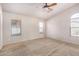 Spacious bedroom with three windows and a ceiling fan at 41848 W Michaels Dr, Maricopa, AZ 85138