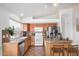 Well-lit kitchen with stainless steel appliances, a breakfast bar, and ample counter space at 41848 W Michaels Dr, Maricopa, AZ 85138