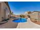 Backyard pool with hot tub and block fence providing privacy, surrounded by a cement patio at 41848 W Michaels Dr, Maricopa, AZ 85138
