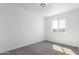 Bright bedroom features neutral walls, carpet, and a window offering natural light at 4625 W Thomas Rd # 19, Phoenix, AZ 85031