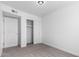 This bedroom is complete with neutral walls, carpet, and closet space at 4625 W Thomas Rd # 19, Phoenix, AZ 85031