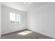 Bright, vacant bedroom showcasing large window and neutral carpeting for a clean, open feel at 4625 W Thomas Rd # 19, Phoenix, AZ 85031
