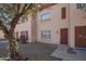 Inviting townhouse featuring a secure entrance and a well-kept lawn with a mature tree at 4625 W Thomas Rd # 19, Phoenix, AZ 85031