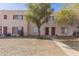 Charming townhome featuring a well-manicured front yard with mature tree and a welcoming walkway at 4625 W Thomas Rd # 19, Phoenix, AZ 85031