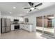 Modern kitchen with stainless steel appliances, white cabinets, and a sliding glass door at 4625 W Thomas Rd # 19, Phoenix, AZ 85031