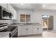 Close-up of sleek kitchen with granite countertops, stainless steel appliances, and modern white cabinets at 4625 W Thomas Rd # 19, Phoenix, AZ 85031