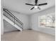 Open living area with staircase, tiled flooring, and a window for natural light at 4625 W Thomas Rd # 19, Phoenix, AZ 85031