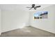 Sunny bedroom with neutral carpet, bright window view, and ceiling fan at 4743 W Laurel Ln, Glendale, AZ 85304