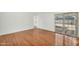 Bright bedroom featuring wood floors, a large sliding door, and neutral walls at 4743 W Laurel Ln, Glendale, AZ 85304