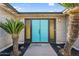 Eye-catching turquoise double front door framed by black trim and desert landscaping at 4743 W Laurel Ln, Glendale, AZ 85304