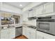 Well-lit kitchen with stainless steel appliances and white cabinetry at 4743 W Laurel Ln, Glendale, AZ 85304